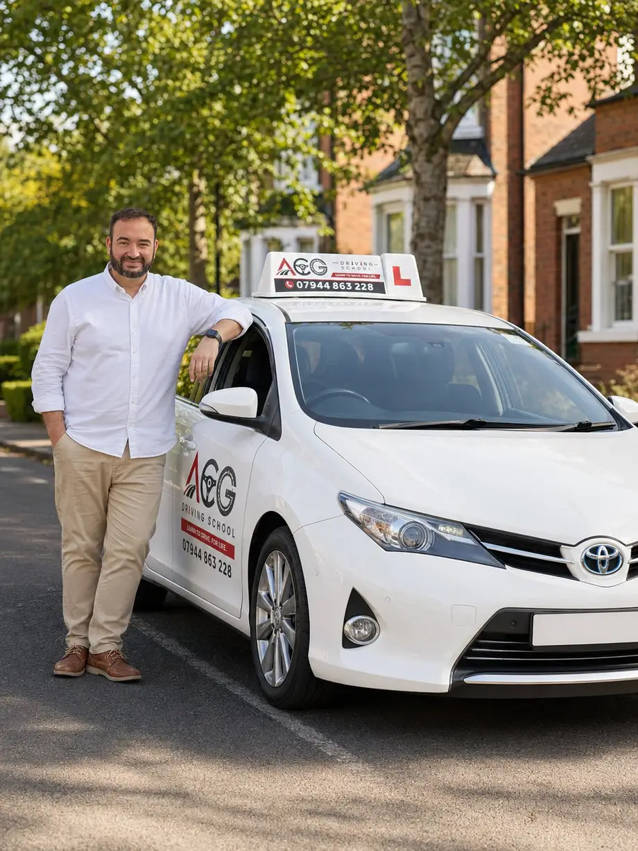 Chedli, the ACG Driving School instructor, beside his branded automatic driving school car on a Nottingham street